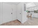 Front door entrance with view into kitchen and dining area at 3827 Pine Cone Cir, Clearwater, FL 33760