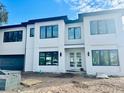 Stunning two-story home with white brick exterior and dark accents at 4608 S Ferdinand Ave, Tampa, FL 33611