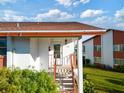 Condo entrance with stairs and landscaping at 4859 Independence Dr, Bradenton, FL 34210