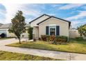 Single-story house with a manicured lawn and navy shutters at 6807 King Creek Dr, Sun City Center, FL 33573
