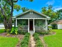 Quaint house with a white porch and a stone pathway leading to the front door at 1003 Beverly Ave, Largo, FL 33770
