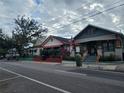 Street view of charming houses with American flags at 2005 E Columbus Dr, Tampa, FL 33605