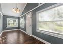 Simple dining room with gray walls, hardwood floors, and white door at 3106 E Trapnell Rd, Plant City, FL 33566