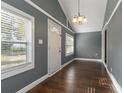 Simple dining room with gray walls, hardwood floors, and white door at 3106 E Trapnell Rd, Plant City, FL 33566