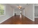 Spacious living room with hardwood floors and ceiling fan at 3106 E Trapnell Rd, Plant City, FL 33566