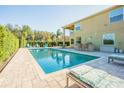Inviting swimming pool with a spacious patio and lounge chairs at 5709 White Trillium Loop, Land O Lakes, FL 34639