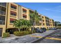 Beautiful condo complex with covered parking, lush landscaping, and mature palm trees at 5817 Park N St # 204, St Petersburg, FL 33709