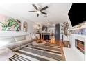 Stylish living room with modern furnishings, a fireplace, and an open concept layout to the kitchen at 727 53Rd N Ter, St Petersburg, FL 33703