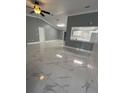 Spacious living room with marble-look floors and a high ceiling at 8601 Twin Lakes Blvd, Tampa, FL 33614