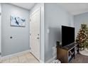 Condo entryway with tiled floors, white door, and a large TV at 10265 Gandy N Blvd # 905, St Petersburg, FL 33702