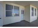 Condo entryway with white door and windows at 1200 Country Club Dr # 2504, Largo, FL 33771