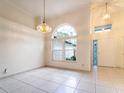 Bright living room with large windows, tiled floor, and elegant lighting fixtures at 1515 Lions Club Dr, Brandon, FL 33511