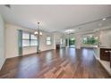 Spacious living room with hardwood floors, fireplace, and access to backyard at 6836 Park Strand Dr, Apollo Beach, FL 33572