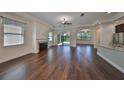 Open living area with hardwood floors, fireplace, and view to kitchen at 6836 Park Strand Dr, Apollo Beach, FL 33572
