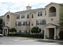 Tan-colored multi-unit residential building with parking and landscaping at 18235 Bridle Club Dr # 18235, Tampa, FL 33647