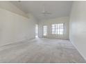 Spacious living room with vaulted ceiling, neutral carpet and an abundance of natural light at 21550 Clubside Loop, Lutz, FL 33549