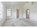 Bright main bedroom with neutral carpet, ensuite access and abundant natural light at 21550 Clubside Loop, Lutz, FL 33549
