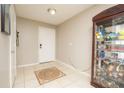 Neutral-toned entryway with tile floors and decorative rug at 2633 Edgewater Falls Dr, Brandon, FL 33511