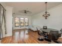 Bright living room featuring hardwood floors and a modern chandelier at 2749 Via Cipriani # 1032A, Clearwater, FL 33764