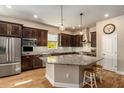 Spacious kitchen featuring granite countertops and dark wood cabinets at 3121 Satilla Loop, Odessa, FL 33556