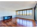 Living room with hardwood floors and large windows with water views at 700 Island Way # 605, Clearwater Beach, FL 33767