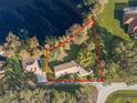 Aerial view of property showcasing the home's location on a large lot next to the lake at 905 Lake Fuller Dr, Lutz, FL 33548