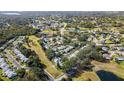 Aerial view showcasing home's location in a community with golf course and lake at 1488 Pheasant Creek Dr, Palm Harbor, FL 34684