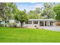 Ranch style home with carport and well-manicured lawn at 20735 Gardenia Dr, Land O Lakes, FL 34638