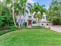 Two-story home with lush landscaping and a manicured lawn at 334 Blanca Ave, Tampa, FL 33606