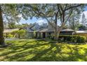 House exterior with a large tree shading the lawn at 3412 Reynoldswood Dr, Tampa, FL 33618