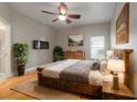 Spacious bedroom with a wooden bed frame and hardwood floors at 3804 N Arlington Ave, Tampa, FL 33603