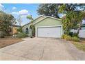 Front view of a light green house with a driveway at 3804 N Arlington Ave, Tampa, FL 33603