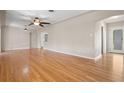 Living room with hardwood floors and view of kitchen at 4156 10Th N Ave, St Petersburg, FL 33713