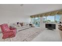 Bright living room with comfortable seating, a large window, and tiled floors at 433 S Paula Dr # 32, Dunedin, FL 34698