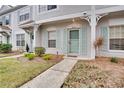 Townhouse entrance with teal door and landscaping at 8635 Hunters Key Cir, Tampa, FL 33647