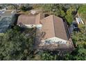 Aerial view of a single Gathering home with a large deck and spacious yard, surrounded by mature trees and greenery at 1149 Sedeeva St, Clearwater, FL 33755