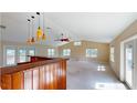 Spacious living room with high ceilings, ceiling fan, and a wet bar for entertaining guests at 1149 Sedeeva St, Clearwater, FL 33755