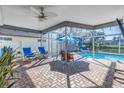 Covered patio with seating area overlooking the pool at 11600 Tradewinds Blvd, Largo, FL 33773