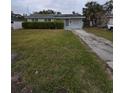 Ranch style home with a large yard and driveway at 121 Pershing Ne St, St Petersburg, FL 33702