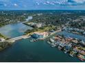 Expansive aerial view of a waterfront condo building, surrounded by lush greenery and waterways at 1860 N Fort Harrison Ave # 104, Clearwater, FL 33755