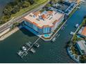 Aerial view of a waterfront building with boat docks, a community pool, and access to main road at 1860 N Fort Harrison Ave # 104, Clearwater, FL 33755