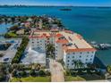 Waterfront building showcasing stunning water views, multiple docks and beautiful landscaping all around at 1860 N Fort Harrison Ave # 104, Clearwater, FL 33755