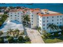 Beautiful waterfront building featuring lush landscaping and a circular driveway leading to the entrance at 1860 N Fort Harrison Ave # 104, Clearwater, FL 33755
