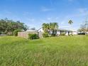 Side view of the house showcasing a wooden fence and lush green grass at 2000 57Th N St, St Petersburg, FL 33710