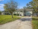 House exterior with a green facade and a driveway at 4911 S 79Th St, Tampa, FL 33619