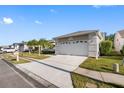 Front view of house with garage, landscaping, and driveway at 601 Canal Way, Oldsmar, FL 34677