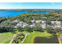 Scenic aerial view of condo community with golf course, lake, and lush landscaping, offering a serene and luxurious lifestyle at 6325 Stone River Rd, Bradenton, FL 34203