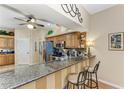 Stylish kitchen featuring granite countertops, stainless steel appliances, a breakfast bar, and ample cabinet space at 6325 Stone River Rd, Bradenton, FL 34203