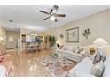 Inviting living room with hardwood floors, comfortable seating, and an open layout to the dining area at 6325 Stone River Rd, Bradenton, FL 34203