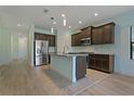 Modern kitchen featuring stainless steel appliances and an island at 13584 Old Creek Ct, Parrish, FL 34219